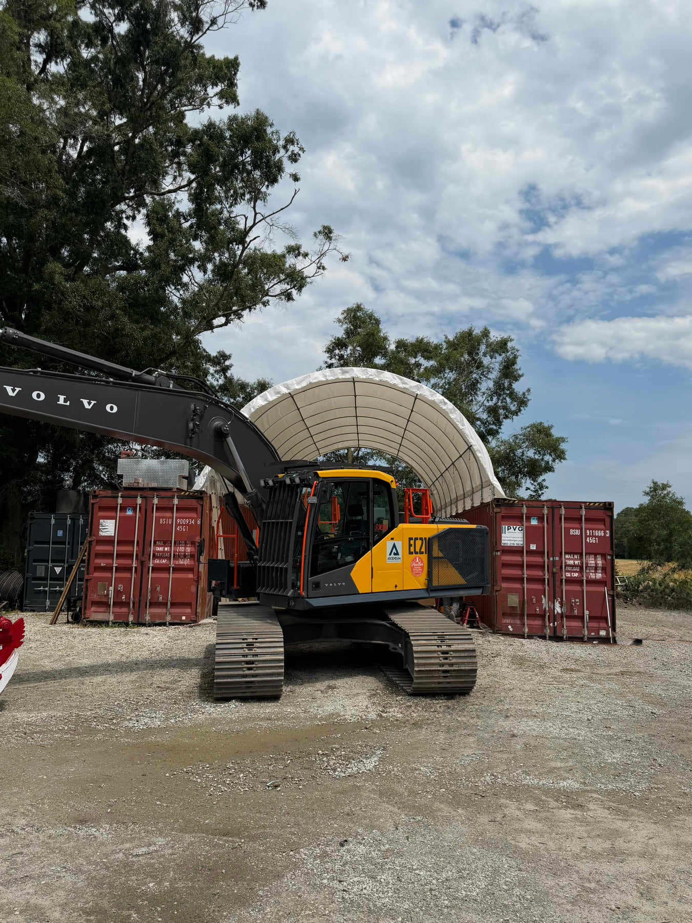 Container-supported fabric shelter creating a covered equipment bay