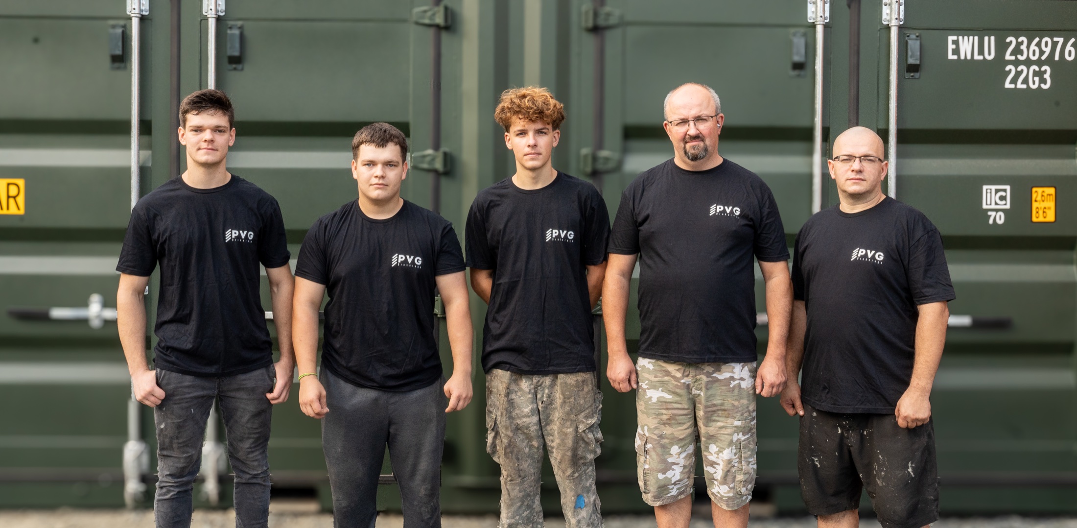 PVG fabrication crew standing in front of a modified shipping container